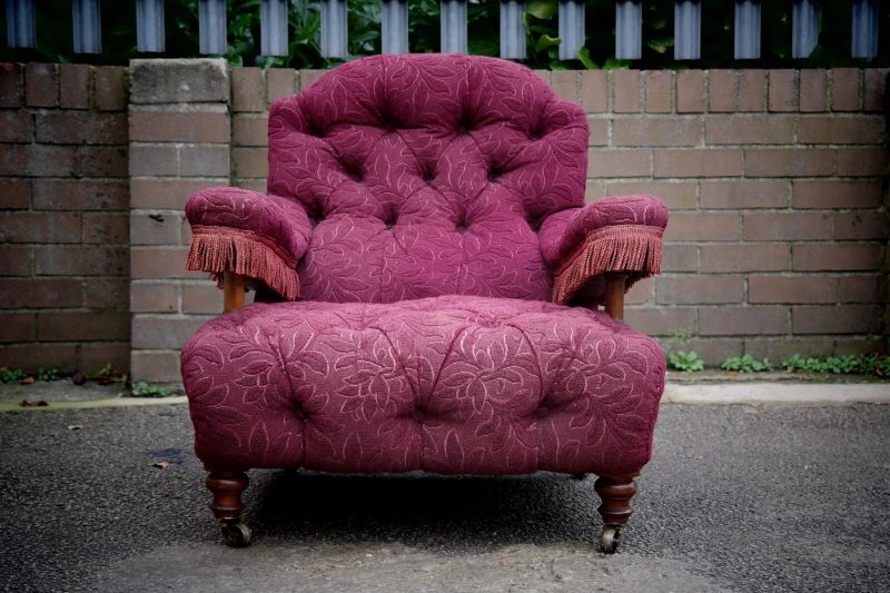 A Howard & Sons buttoned open armchair in Heavy Burgundy Fabric - Image 4